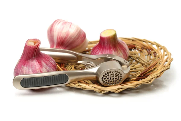 Garlic press and garlic — Stock Photo, Image