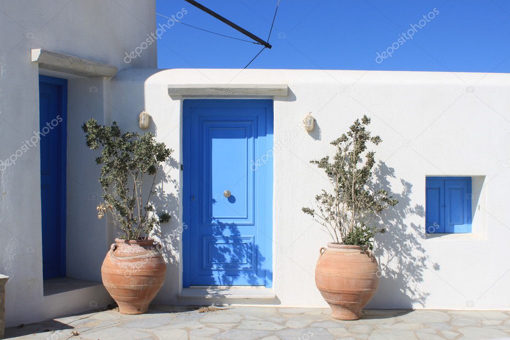 The white facade with a blue door
