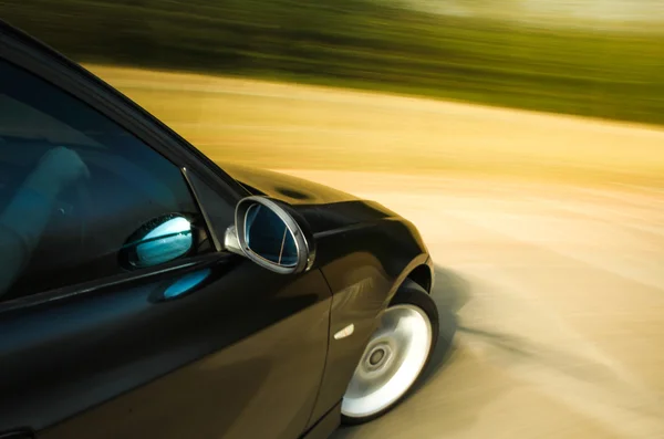 View of black luxury sedan driving fast. — Stock Photo, Image