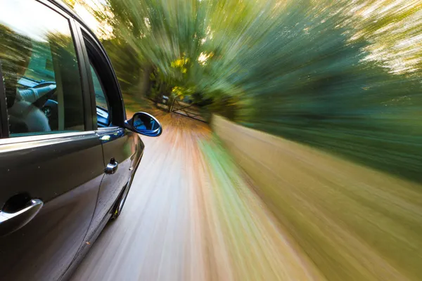 Side view of speeding sedan — Stock Photo, Image