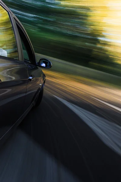 Side view of speeding sedan — Stock Photo, Image