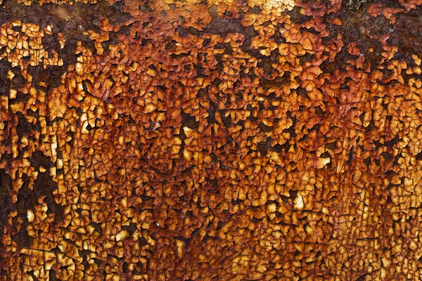 Rusty yellow paint on metal plate