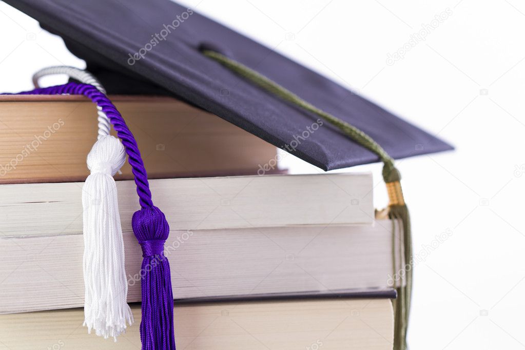 Cap and cords on books, achievement and education symbols