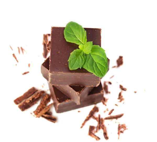 Closeup of chocolate parts and mint leaves on white background — Stock Photo, Image