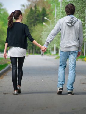 Genç çiftin birlikte parkta yürüyüş