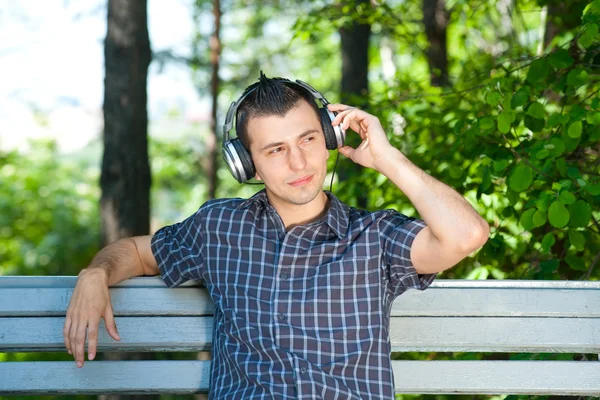 Portrait of a young man listening to music outdoors — Stock Photo, Image