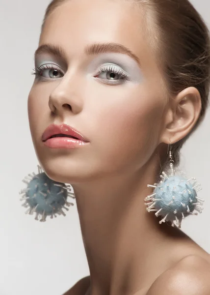 Beautiful woman with fancy earrings — Stock Photo, Image