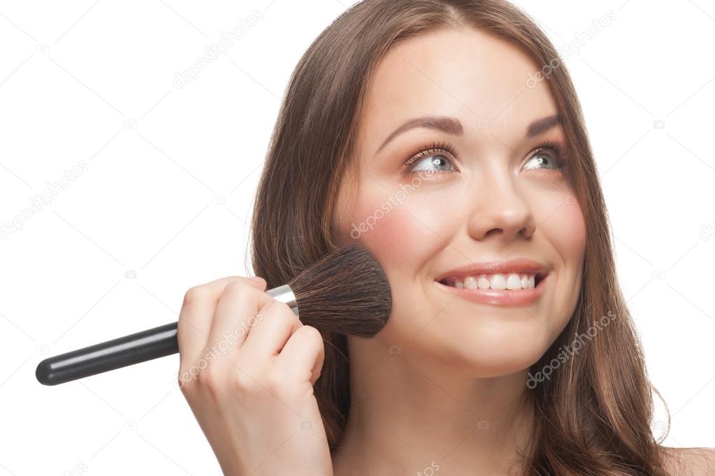 Pretty woman applying makeup