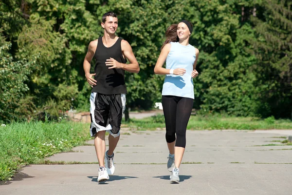 Fitness couple jogging in park — Stock Photo, Image