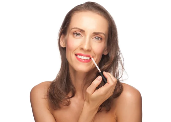 Woman putting on lip gloss — Stock Photo, Image