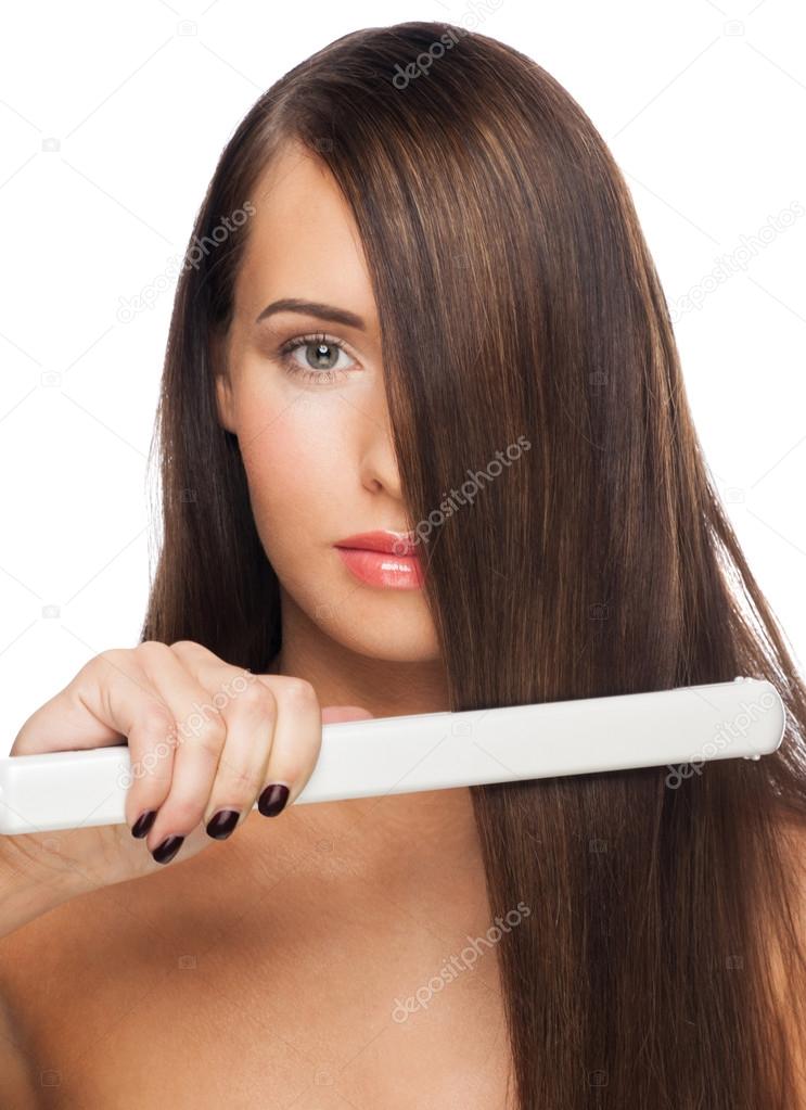 Woman with hair straightening irons