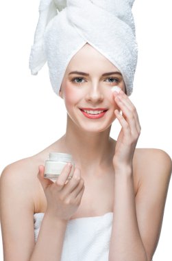 Beautiful woman applying moisturizing cream clipart