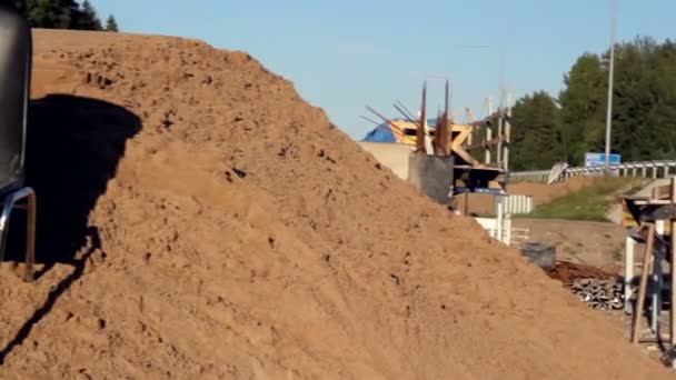 Black chair standing on top of a heap of soil — Stock Video