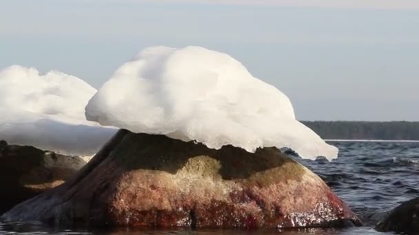 Capuchones de nieve que se derriten lentamente sobre rocas — Vídeo de stock