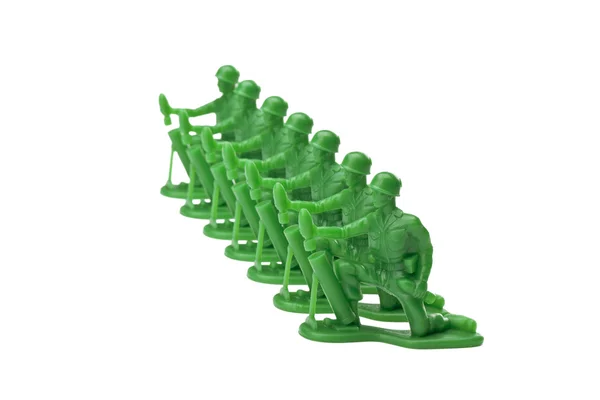 Green toy soldiers kneeling on the ground — Stock Photo, Image