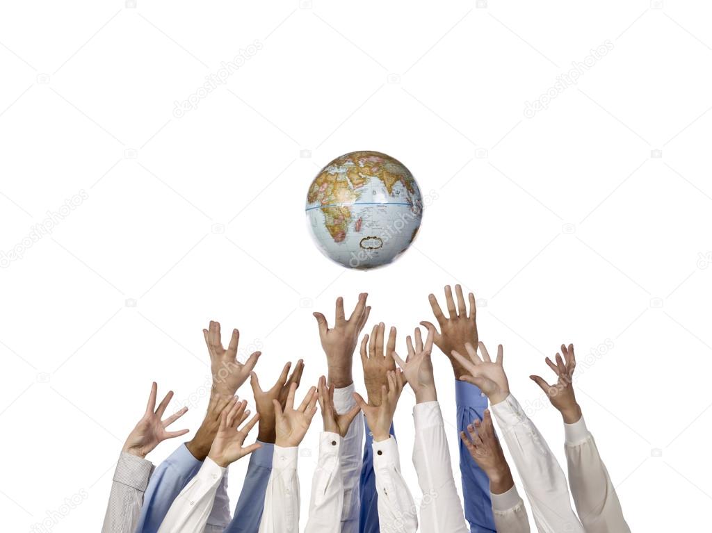 Many hands reaching up on the globe