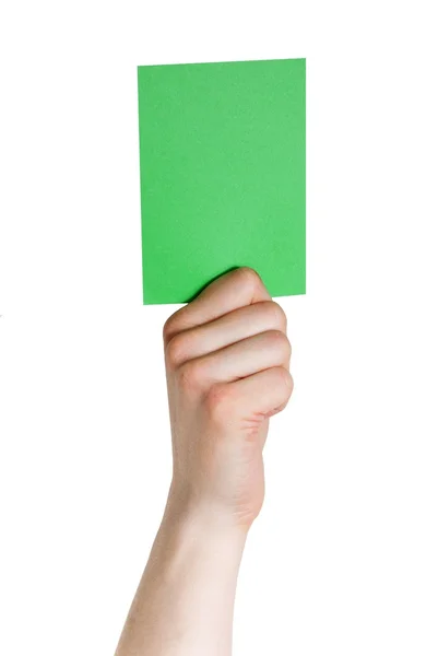 Hand som håller en grön etikett — Stockfoto