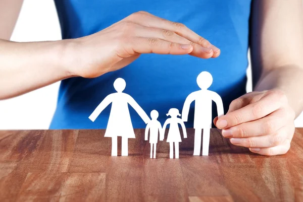 Hand protecting a family — Stock Photo, Image