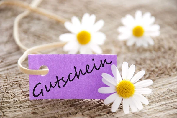 Etiqueta púrpura con Gutschein en ella — Foto de Stock