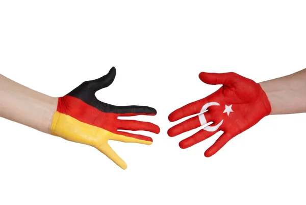 Hands with german and turkey flag — Stock Photo, Image