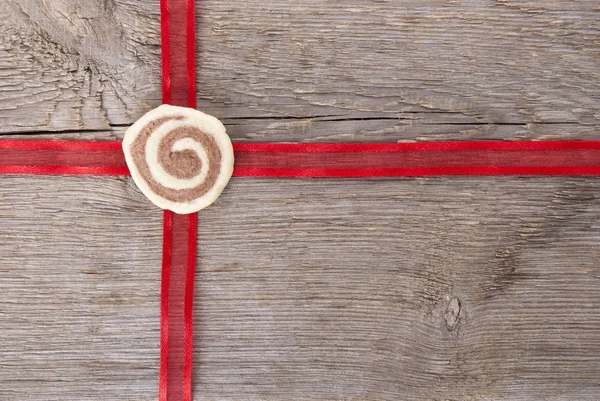 Red ribbon on wood — Stock Photo, Image