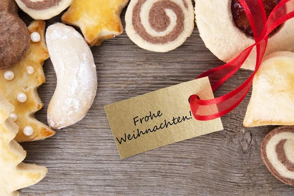 Christmas cookie bakgrund med frohe weihnachten — Stockfoto