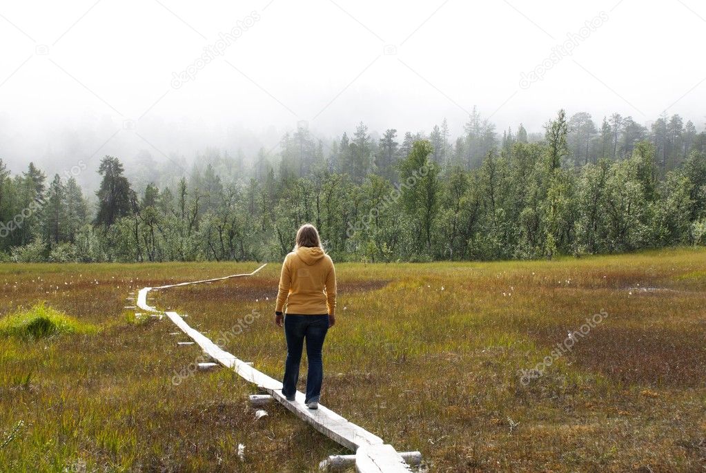 A Woman Walking on a Path