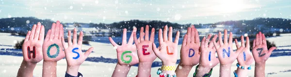 Παιδιά Χέρια οικοδόμηση Word Hos Geldiniz σημαίνει Καλώς ήρθατε, χιονισμένο φόντο χειμώνα — Φωτογραφία Αρχείου