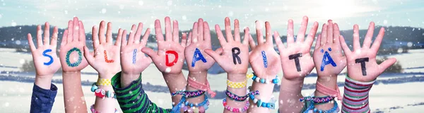 Kids Hands Holding Word Solidaritaet Means Solidarity, Snowy Winter Background — Stock Photo, Image