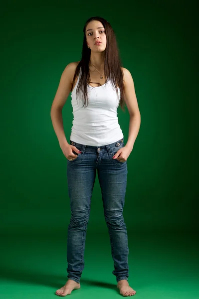 Um retrato de uma jovem mulher bonita vestindo jeans e singlet — Fotografia de Stock