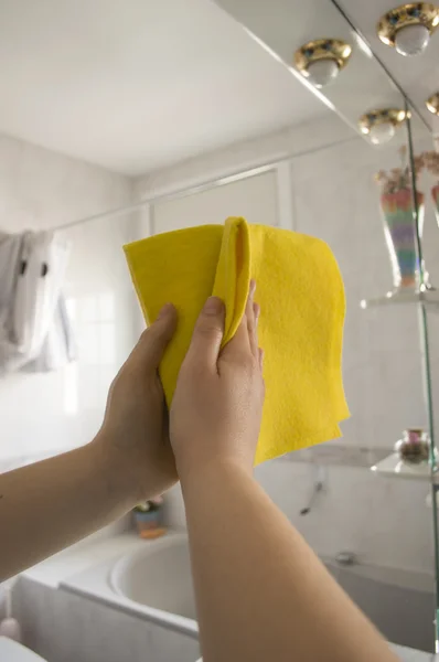 Woman cleaning cloth mirror — Stock Photo, Image