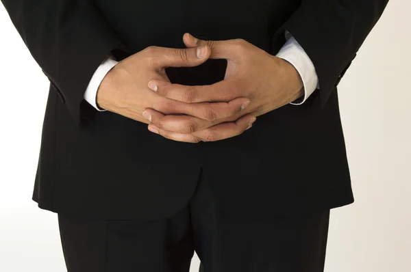 Empresário esperando com as mãos dobradas — Fotografia de Stock