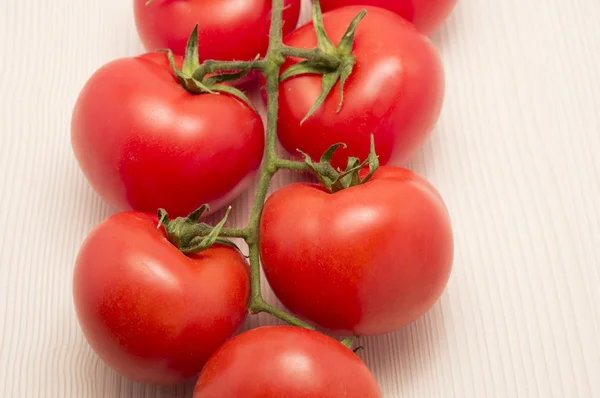 Vine tomatoes on a table with close up — Stock Photo, Image