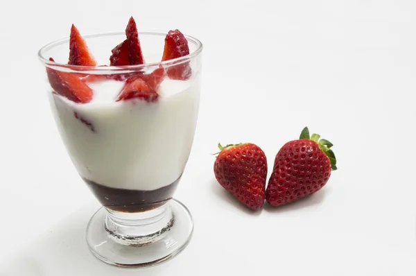 Glass of yogurt with strawberries blur isolated on white — Stock Photo, Image