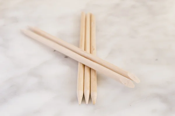 Cuticle pushers on marble orange sticks — Stock Photo, Image