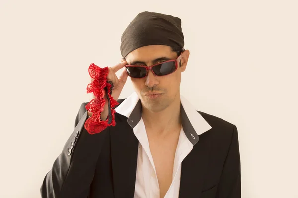 Latin lover with a garter red in hand — Stock Photo, Image