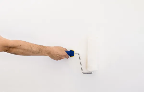 Closeup of a hand with paint roller with space copy — Stock Photo, Image