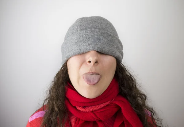 Hat and sticking out her tongue — Stock Photo, Image