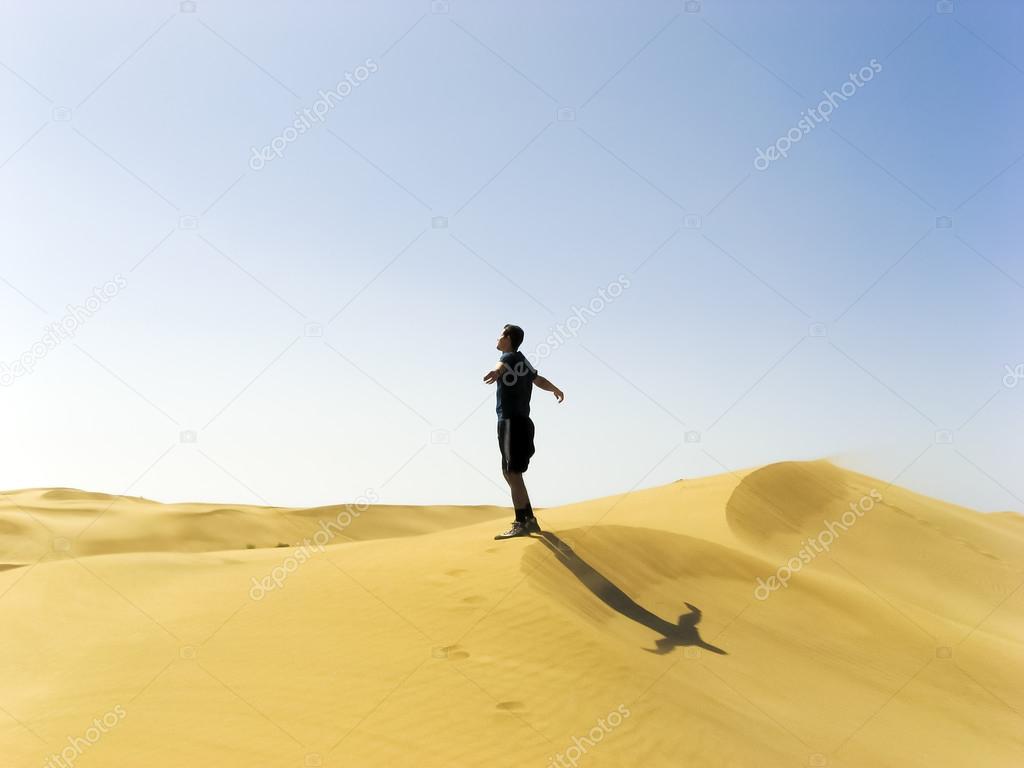 man stretching in the dunes of Gran Canaria