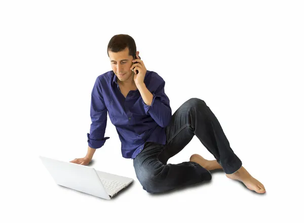 Talking on phone and looking at his computer — Stock Photo, Image