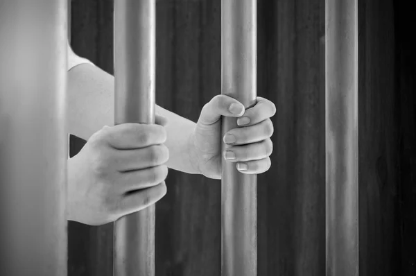 Grabbed the bars of the prison — Stock Photo, Image