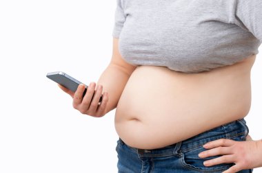 Plump woman holding smartphone in hands, texting, reading message, or using new application, isolated on white background with free space