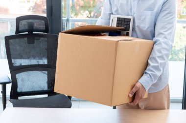 Cropped shot of a businessman leaving work with a box with his objects at office