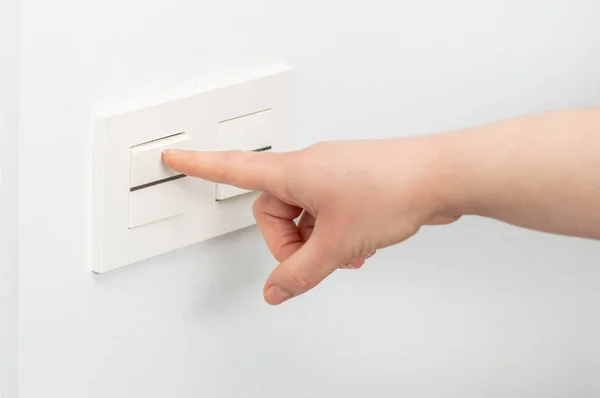 Close Woman Hand Turning Light Wall Switch — Zdjęcie stockowe