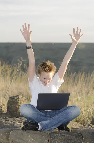 Teenager joyously throws his hands up — Stock Photo, Image