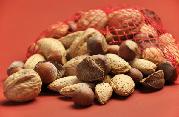 Healthy Food - Nuts on a Terra-cotta Background with Shallow DOf — Stock Photo, Image
