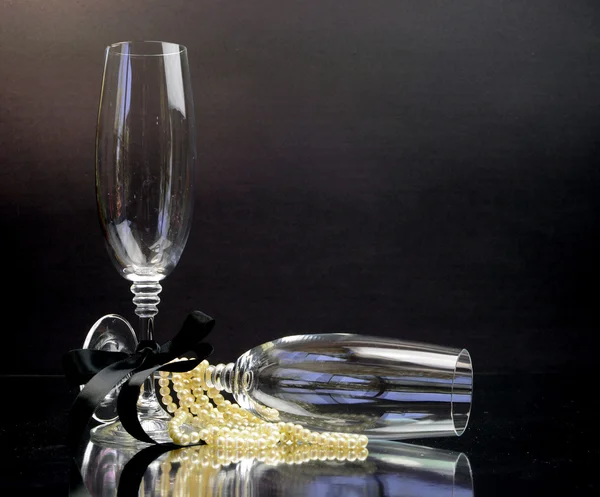 Champagne Glasses for black tie occasion celebration or New Years Eve party on black background. — Stock Photo, Image