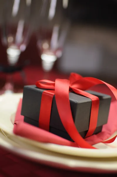 Close-up of black box gift on romantic Valentine table setting. — Stock Photo, Image