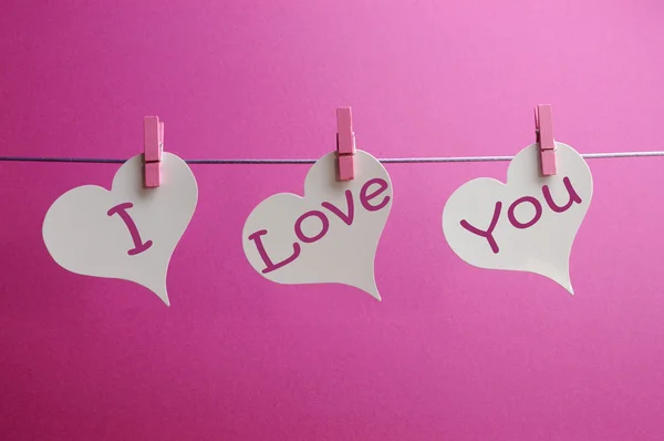 'I love you' message written on hanging white hearts — Stock Photo, Image