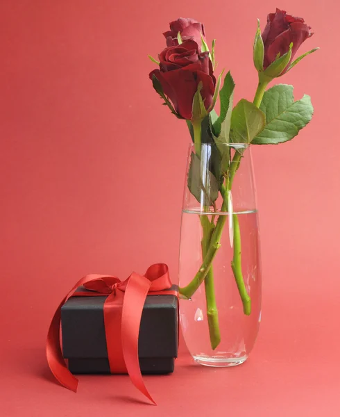 Glückliche Valentinstag schwarze Schachtel mit rotem Band Geschenk und roten Rosen — Stockfoto